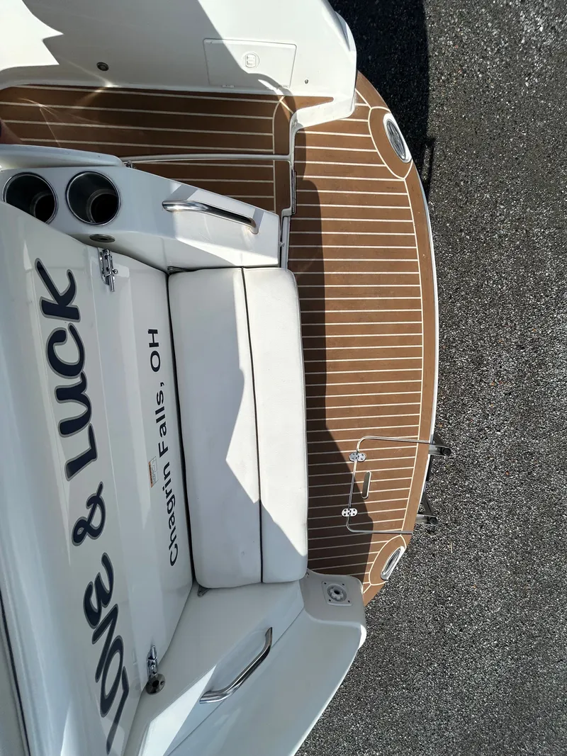 Slide: The Image of 2013 Rinker 290 Express Cruiser with wooden deck and seating. - 44