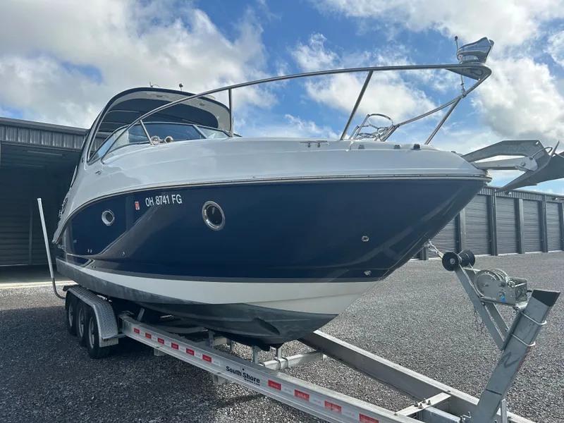 Slide: The Image of 2013 Rinker 290 Express Cruiser on trailer, blue sky. - 8