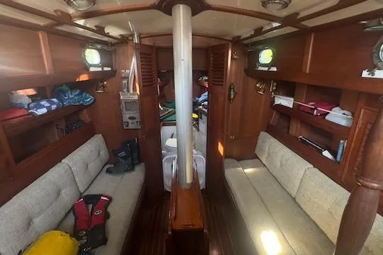 Slide: The Image of Interior of a 1980 Shannon 28 sailboat with cozy seating and wooden finishes. - 4