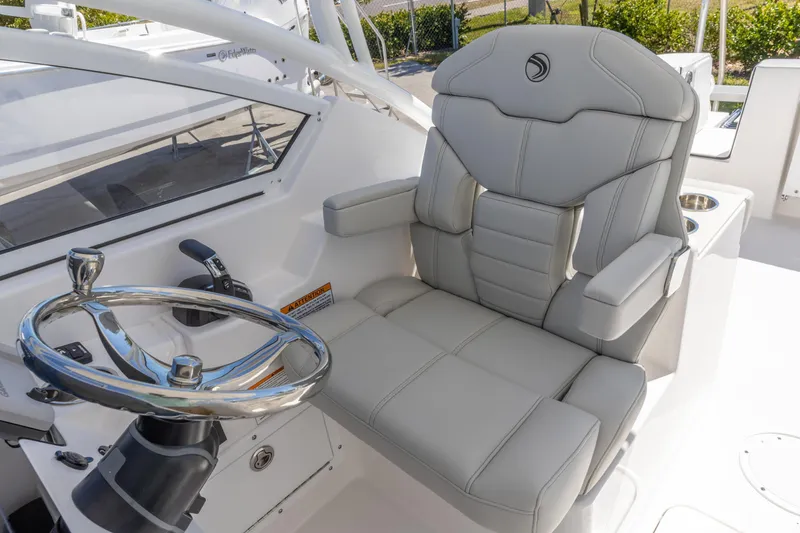 Slide: The Image of Luxurious helm seat and steering wheel on 2026 Edgewater 248CX Crossover boat. - 2