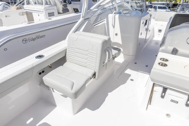 Slide: The Image of 2026 Edgewater 248CX Crossover boat interior with white seating and modern design. - 4