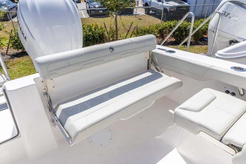 Slide: The Image of 2026 Edgewater 248CX Crossover boat interior with white seating and cup holders. - 5