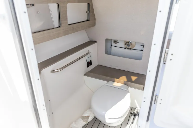 Slide: The Image of 2026 Edgewater 248CX Crossover boat interior bathroom with modern fixtures and compact design. - 6