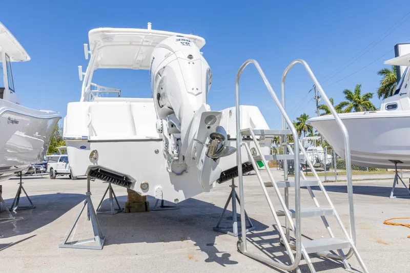 Slide: The Image of 2026 Edgewater 248CX Crossover boat with outboard motor on display. - 7