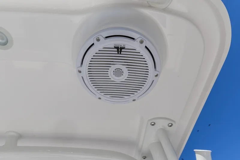 Slide: The Image of Speaker on 2026 Edgewater 248CX Crossover boat against clear blue sky. - 9