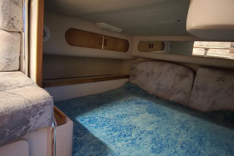 Slide: The Image of Interior cabin of 1996 Sea Ray 290 Sundancer with blue patterned flooring. - 4