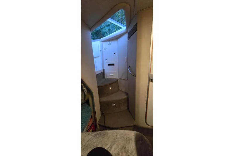 Slide: The Image of Interior view of 1996 Sea Ray 290 Sundancer cabin with stairs and natural light. - 5