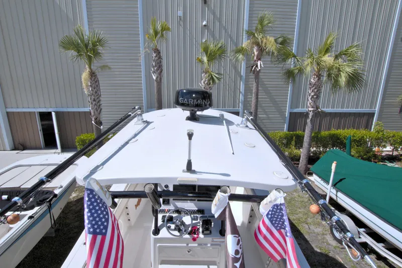 Slide: The Image of 2018 Sea Chaser 27 HFC boat with American flags, palm trees, and Garmin equipment. - 10