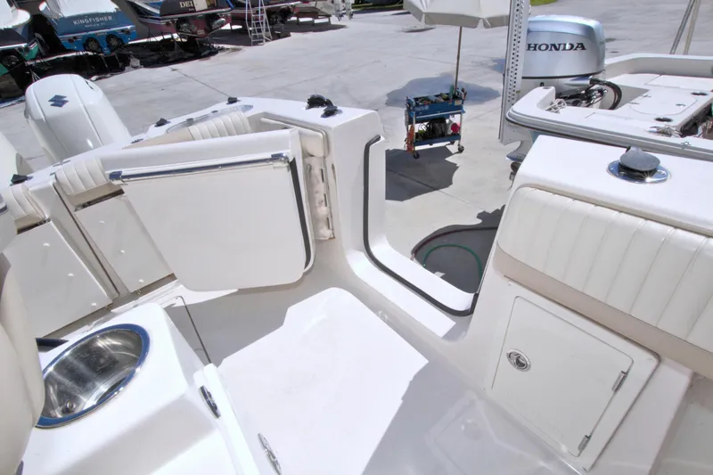Slide: The Image of 2018 Sea Chaser 27 HFC boat interior with open compartments and Honda engine. - 15