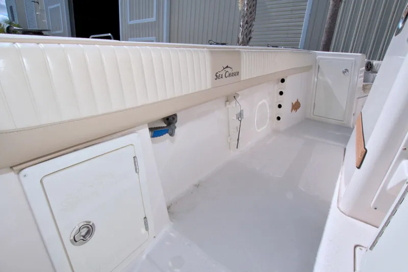 Slide: The Image of 2018 Sea Chaser 27 HFC boat interior, featuring storage compartments and sleek design. - 16