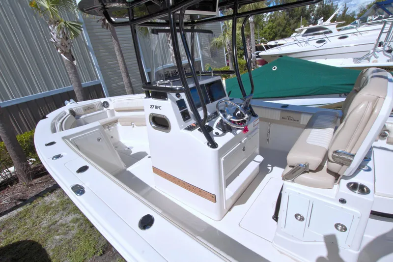 Slide: The Image of 2018 Sea Chaser 27 HFC boat interior with helm and seating area. - 19