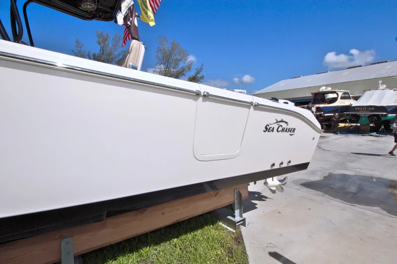 Slide: The Image of 2018 Sea Chaser 27 HFC boat on display outdoors, clear sky background. - 2