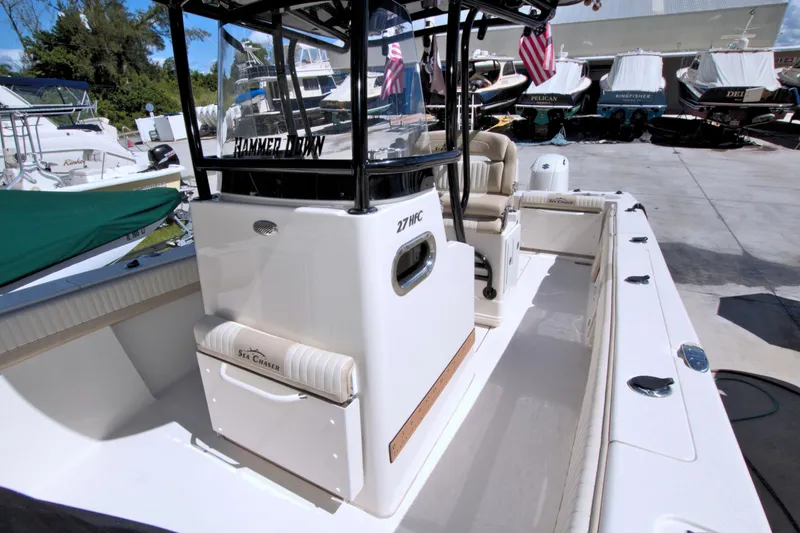 Slide: The Image of 2018 Sea Chaser 27 HFC boat, spacious deck, docked with other vessels. - 22
