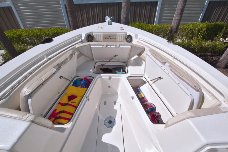 Slide: The Image of 2018 Sea Chaser 27 HFC boat with open storage compartments and colorful gear. - 24