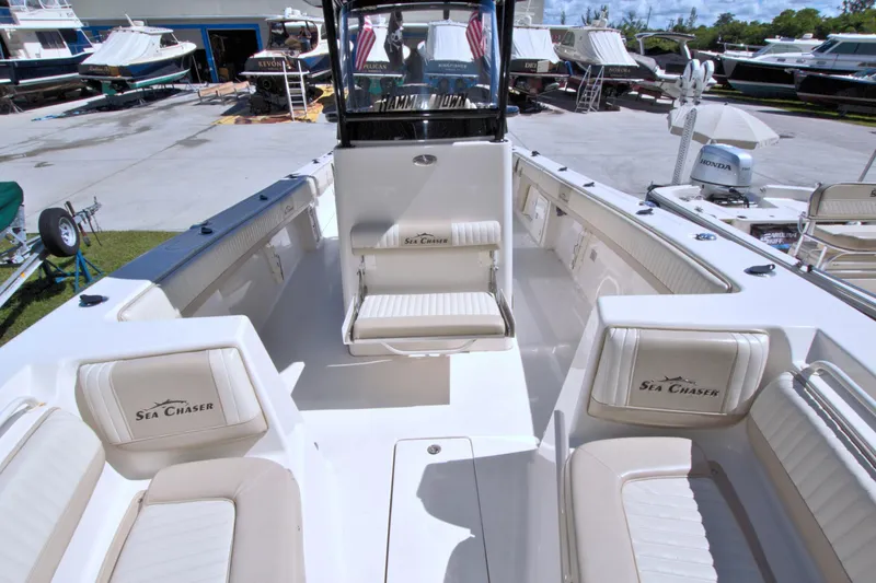 Slide: The Image of 2018 Sea Chaser 27 HFC boat interior with seating and helm. - 27