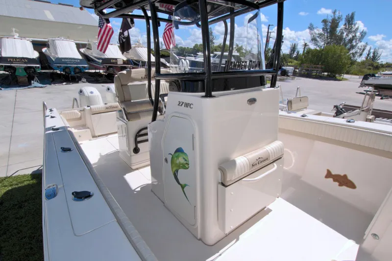 Slide: The Image of 2018 Sea Chaser 27 HFC boat interior with fishing rod holders and seating. - 28