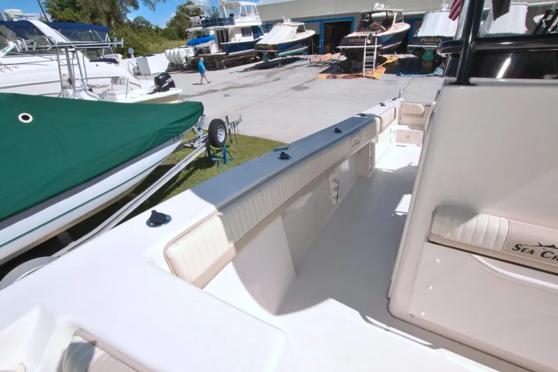 Slide: The Image of 2018 Sea Chaser 27 HFC boat interior at a marina with other boats. - 32