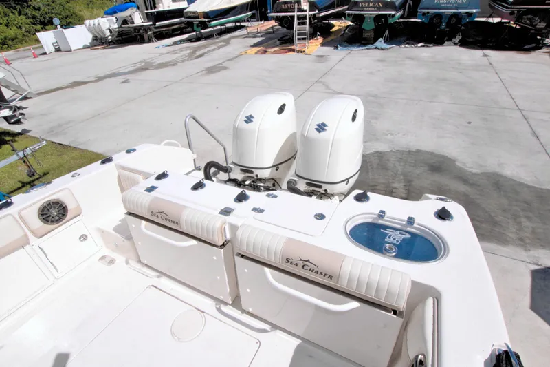 Slide: The Image of 2018 Sea Chaser 27 HFC boat with dual outboard engines in a marina setting. - 36