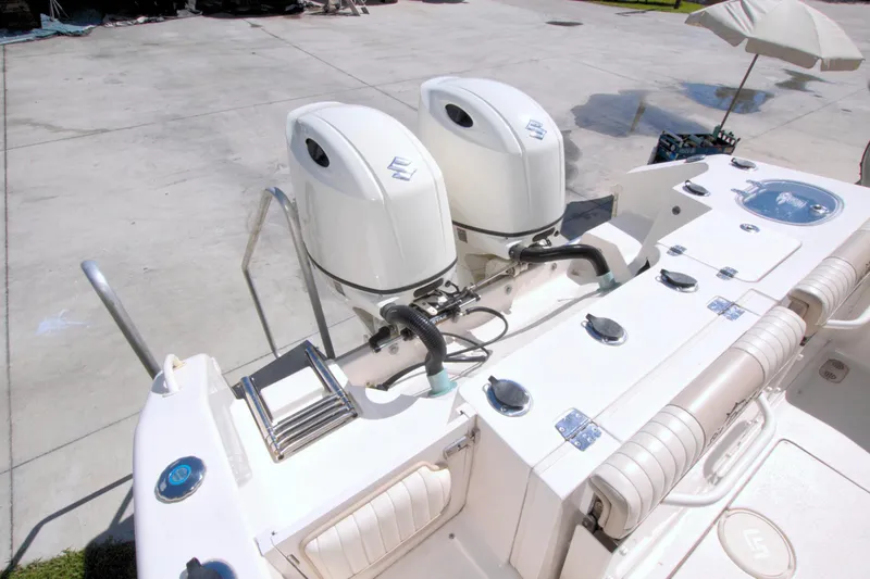 Slide: The Image of 2018 Sea Chaser 27 HFC boat with dual outboard motors, docked on concrete. - 40