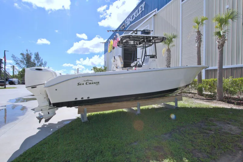 Slide: The Image of 2018 Sea Chaser 27 HFC boat displayed outdoors near a building. - 7