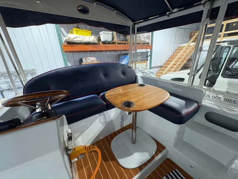 Slide: The Image of Interior of a 2021 Duffy Cuddy Cabin with table and seating. - 49