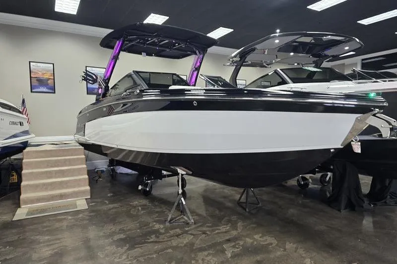 The Image of 2026 Cobalt R8 Surf boat displayed indoors with sleek black and white design. - 2