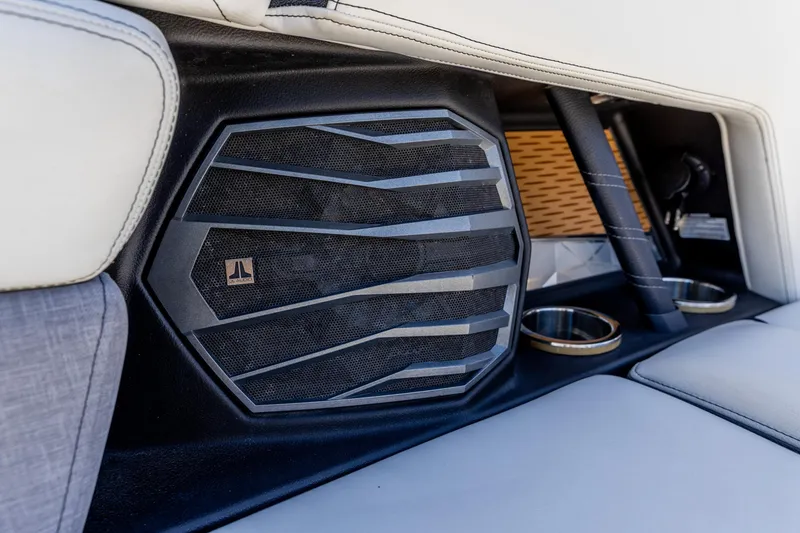 Slide: The Image of 2022 Nautique Super Air Nautique G23 interior speaker and cup holders detail. - 10