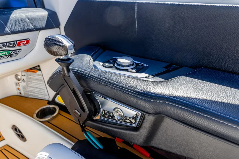 Slide: The Image of 2022 Nautique Super Air Nautique G23 boat control panel and throttle lever. - 11