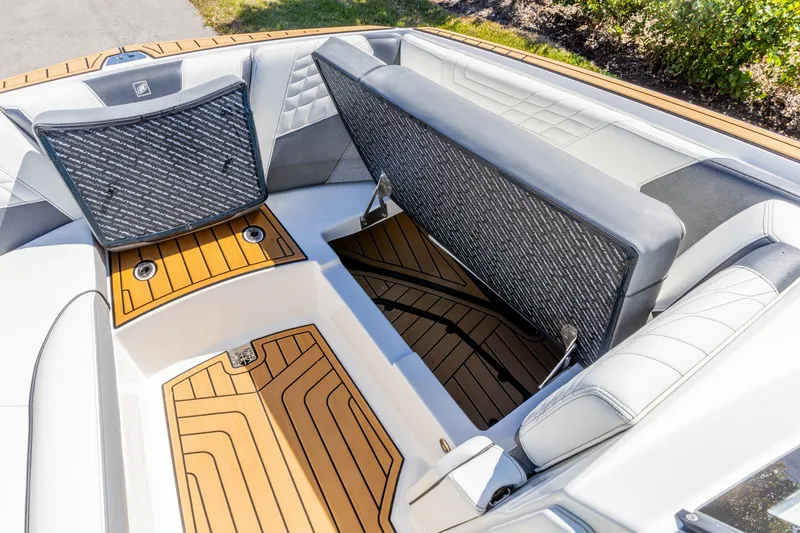 Slide: The Image of 2022 Nautique Super Air Nautique G23 boat interior with open storage compartments. - 14