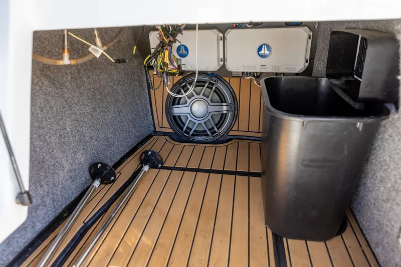 Slide: The Image of 2022 Nautique Super Air Nautique G23 interior storage with speaker and wiring. - 17