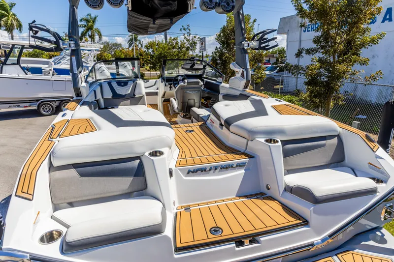 Slide: The Image of 2022 Nautique Super Air Nautique G23 boat with luxurious seating and modern design. - 2