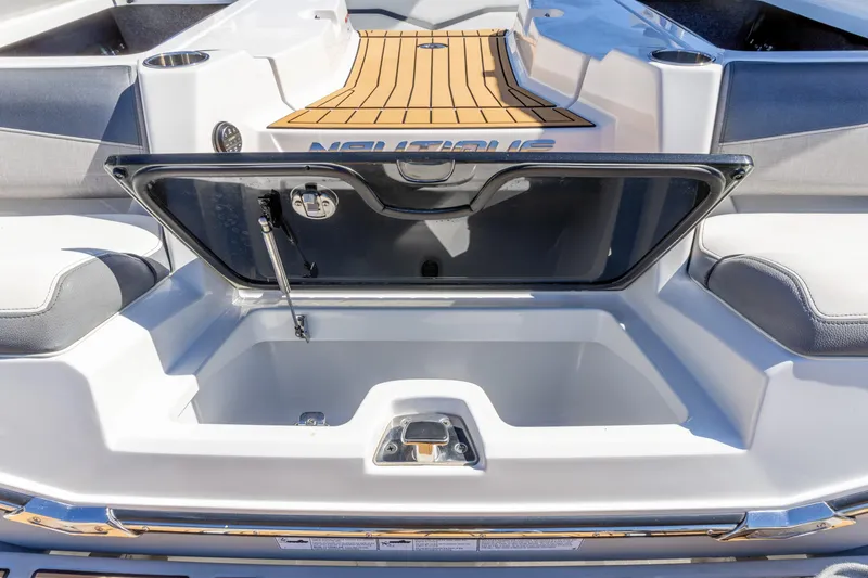 Slide: The Image of 2022 Nautique Super Air Nautique G23 boat storage compartment open, showcasing interior space. - 23