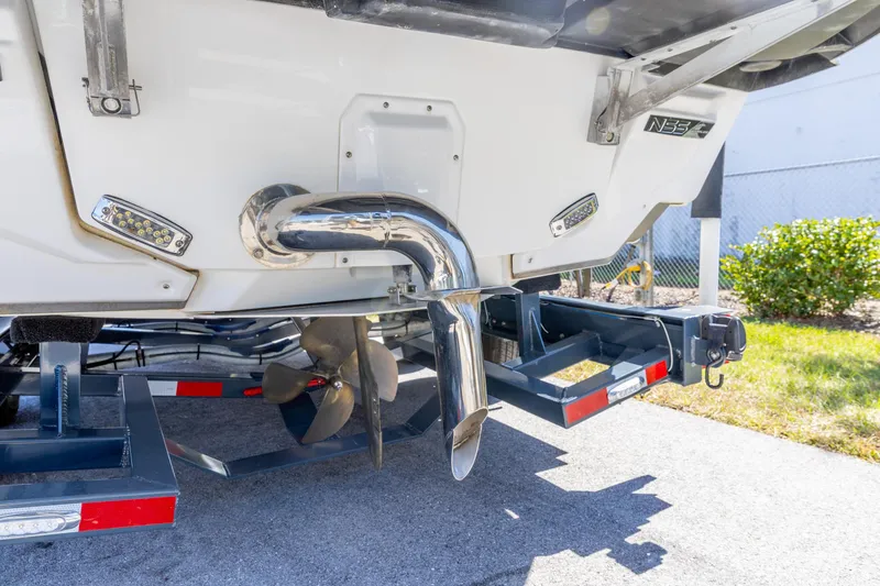 Slide: The Image of 2022 Nautique Super Air Nautique G23 boat stern with propeller and exhaust system. - 25