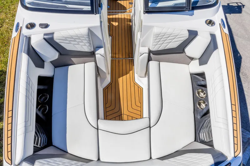 Slide: The Image of 2022 Nautique Super Air Nautique G23 interior with luxurious seating and teak flooring. - 5