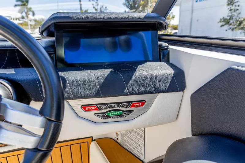 Slide: The Image of 2022 Nautique Super Air Nautique G23 dashboard with touchscreen and control buttons. - 6