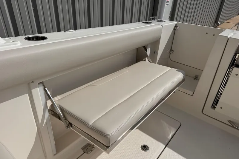 Slide: The Image of 2026 Sailfish 276 DC boat with foldable seating and cup holders. - 11