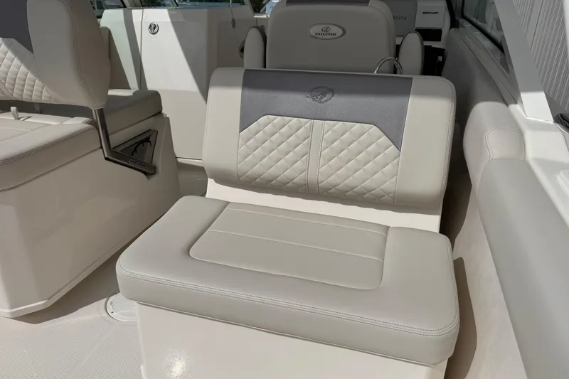Slide: The Image of 2026 Sailfish 276 DC boat interior with luxurious beige seating and quilted design. - 12