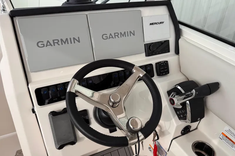 Slide: The Image of 2026 Sailfish 276 DC helm with Garmin displays and Mercury controls. - 19