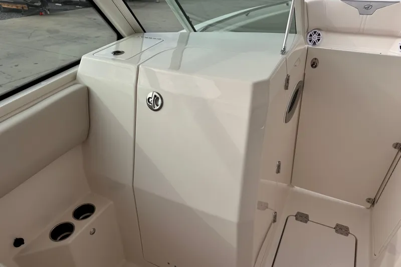 Slide: The Image of 2026 Sailfish 276 DC boat interior with storage compartments and cup holders. - 20