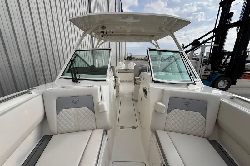 Slide: The Image of 2026 Sailfish 276 DC boat interior with cushioned seating and open deck design. - 26