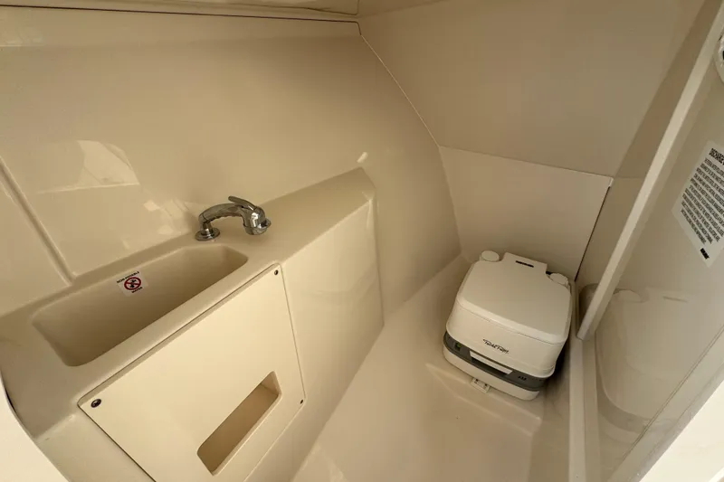 Slide: The Image of 2026 Sailfish 276 DC boat interior with sink and portable toilet. - 27