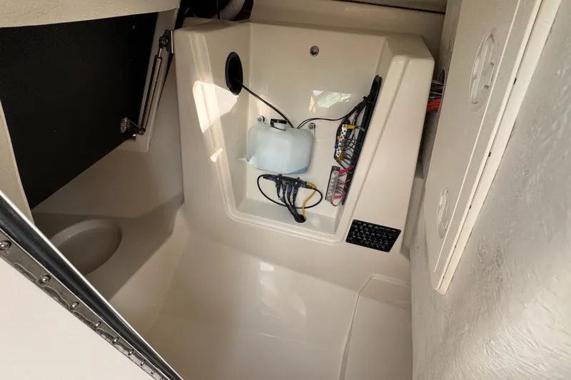 Slide: The Image of Interior of 2026 Sailfish 276 DC boat, featuring storage and wiring compartment. - 28