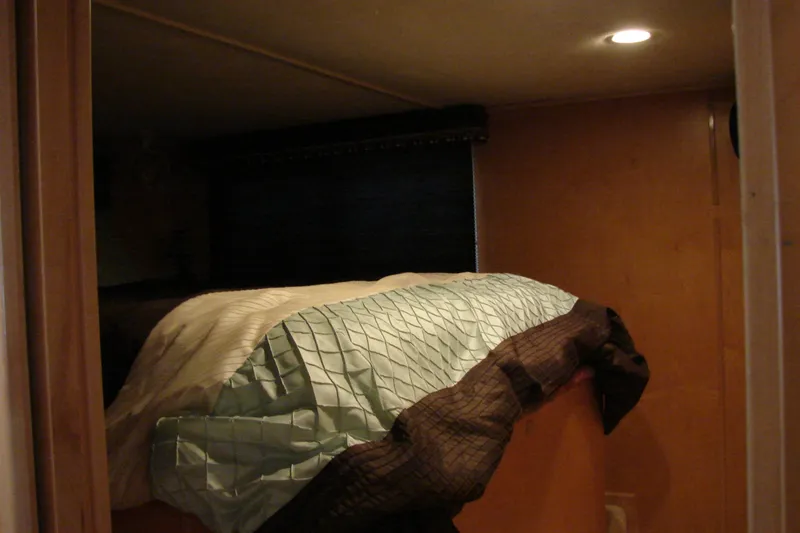 Slide: The Image of Cozy bedroom interior in 1999 Sumerset 18x90 houseboat with soft lighting. - 17