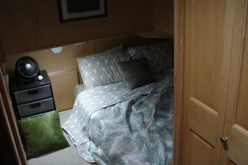 Slide: The Image of Cozy bedroom in 1999 Sumerset 18x90 houseboat with patterned bedding and small fan. - 21