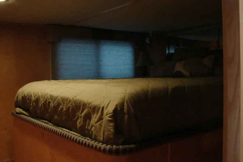 Slide: The Image of Cozy bedroom interior of 1999 Sumerset 18x90 houseboat with a comfortable bed. - 22