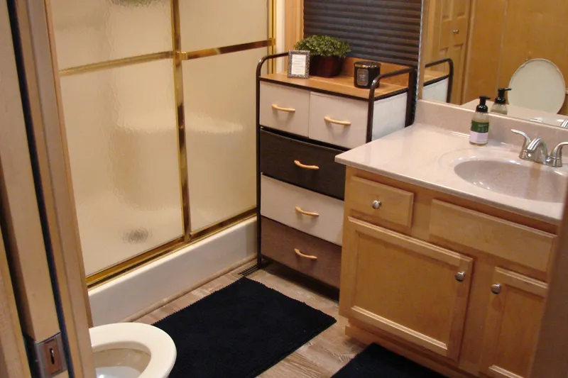 Slide: The Image of Bathroom interior of 1999 Sumerset 18x90 houseboat with shower, sink, and storage. - 23