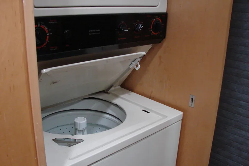 Slide: The Image of Washing machine in a 1999 Sumerset 18x90 houseboat interior, open lid, wooden paneling. - 24