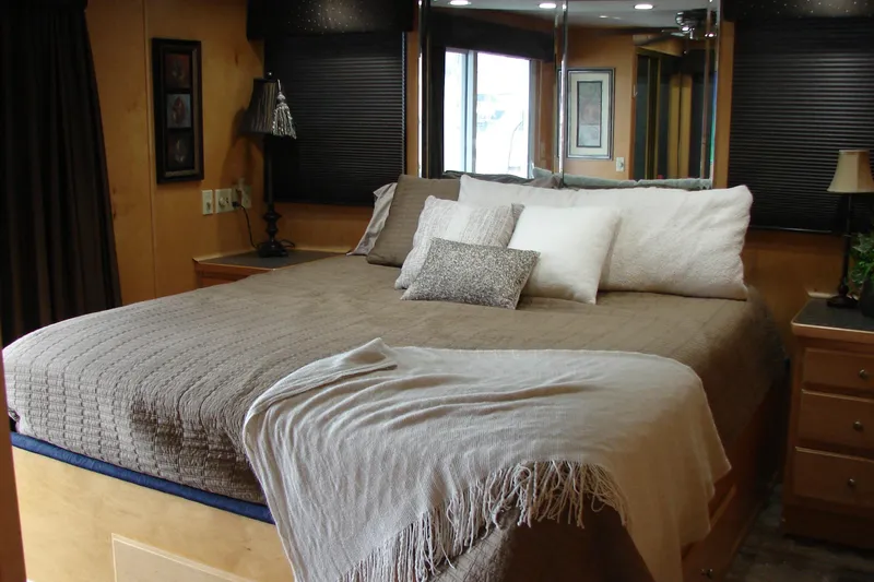 Slide: The Image of Cozy bedroom interior in 1999 Sumerset 18x90 houseboat with elegant bedding and decor. - 25