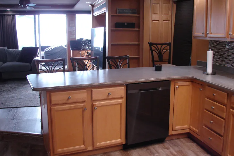 Slide: The Image of Kitchen interior of 1999 Sumerset 18x90 houseboat with wooden cabinets and modern appliances. - 27