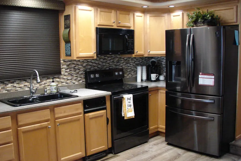 Slide: The Image of Modern kitchen in a 1999 Sumerset 18x90 houseboat with stainless steel appliances. - 28